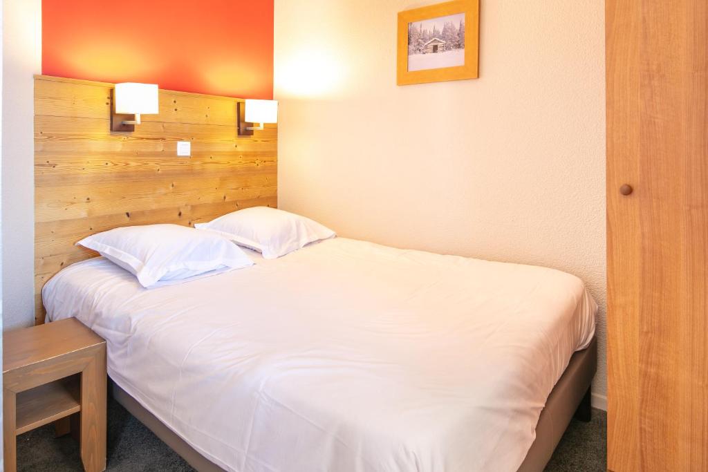 Кровать или кровати в номере Résidence Pierre & Vacances L'Ours Blanc