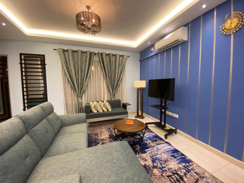 ein Wohnzimmer mit einem Sofa und einem TV in der Unterkunft DD Homestay Pasir Gudang in Pasir Gudang