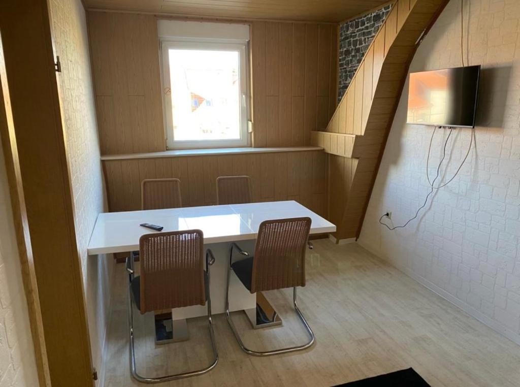 a room with a table and two chairs and a window at Goethestraße in Staßfurt