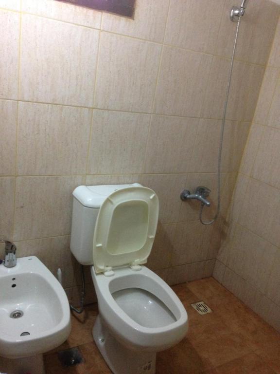 a bathroom with a toilet and a sink at Complejo Valhalla 6 in Mar Azul
