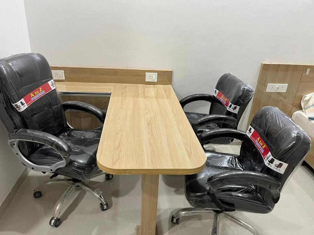 two desks and two chairs in an office at Gaur City Centre in Ghaziabad