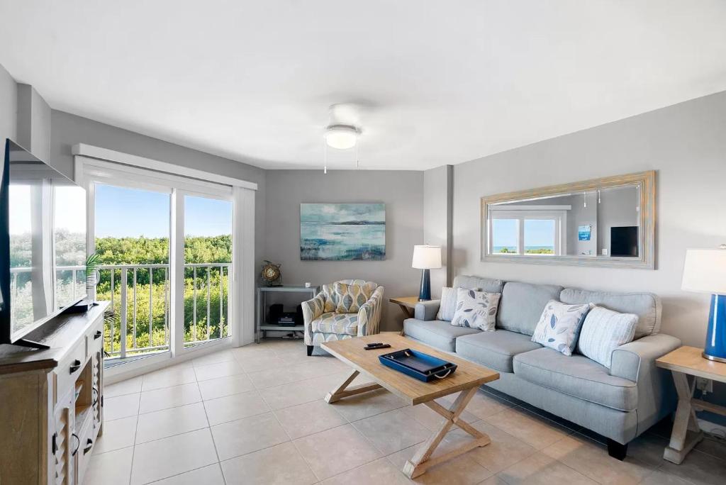 a living room with a couch and a table at Tropical Getaway w/Private Beach 1 BD Condo in Tavernier