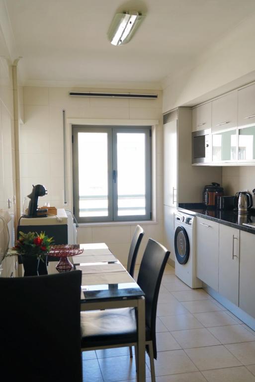 a kitchen with a table and chairs and a dining room at Always on the way - Road Home in Montijo, Lisbon in Montijo