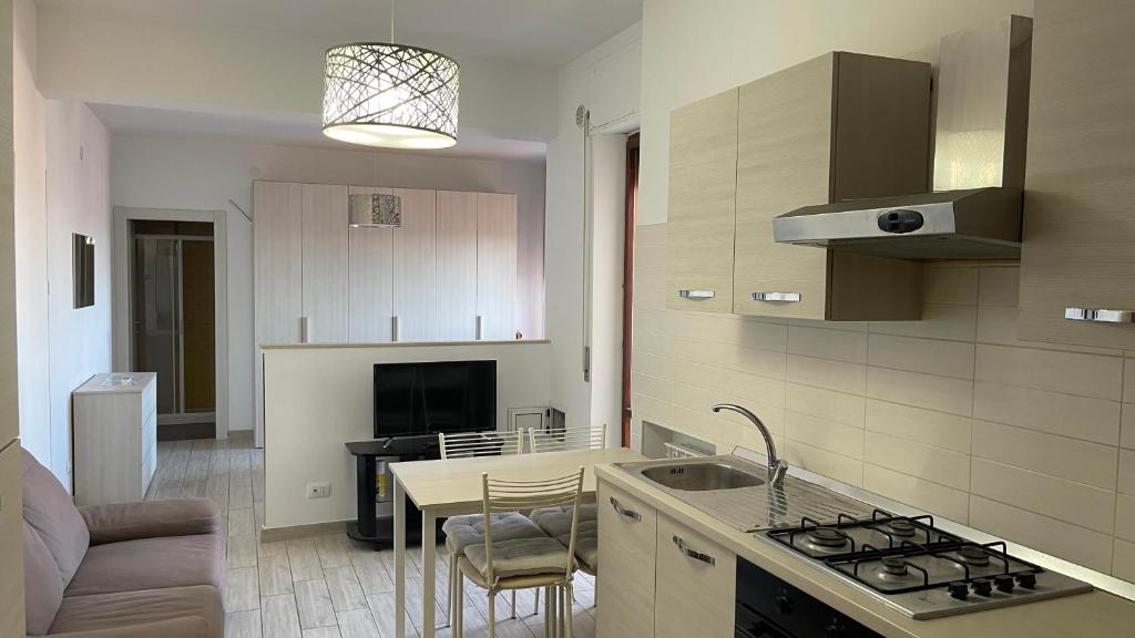 a kitchen with a sink and a stove top oven at Il Rifugio Nel Cielo in Termoli