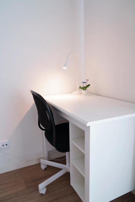a white desk with a chair and a lamp at Always on the way - Road Home in Montijo, Lisbon in Montijo