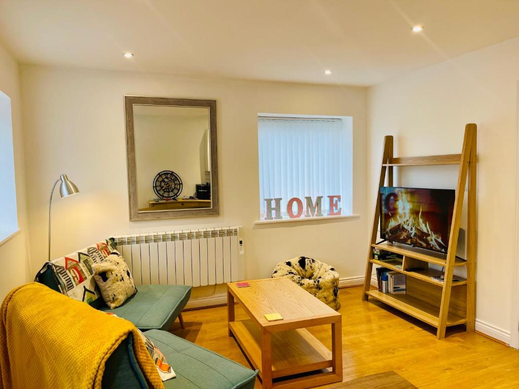a living room with a couch and a table at Our Happy Place- 2 bedroom apartment with designated parking - Brixham in Brixham