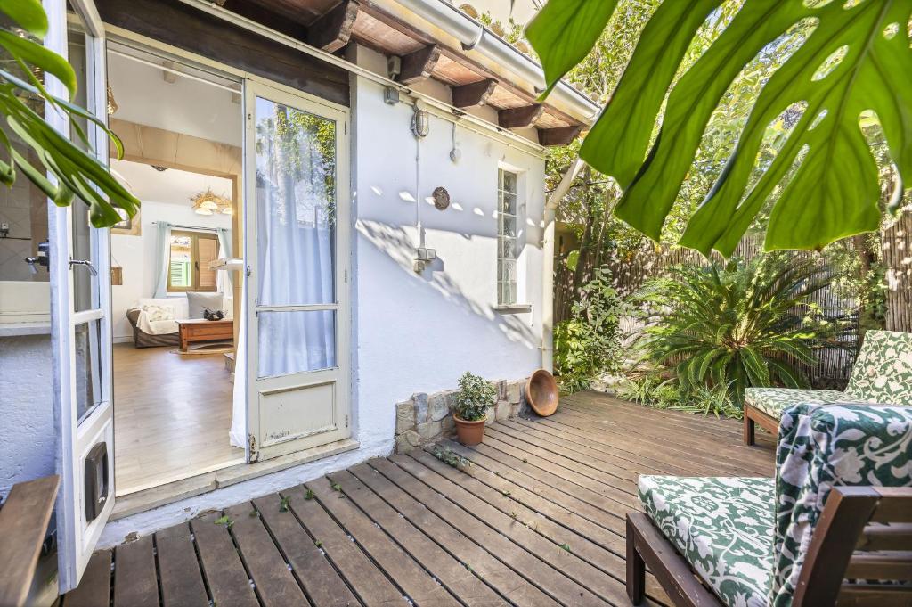 a patio with a door and chairs on a deck at Ca's Tauler in Esporles