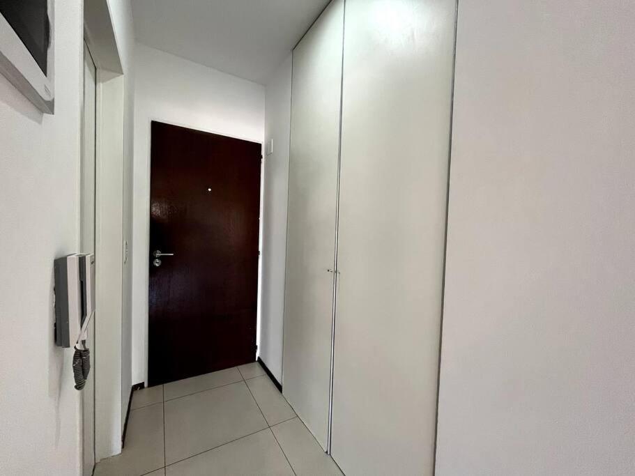 a hallway with a dark door and a corridor with a corridorngthngthngthngth at Moderno y Luminoso Departamento in Buenos Aires