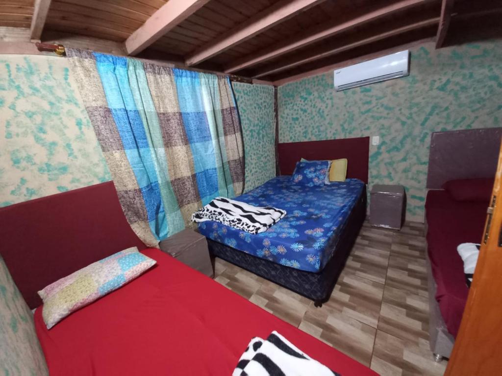 En eller flere senger på et rom på Cabaña Doña Angela