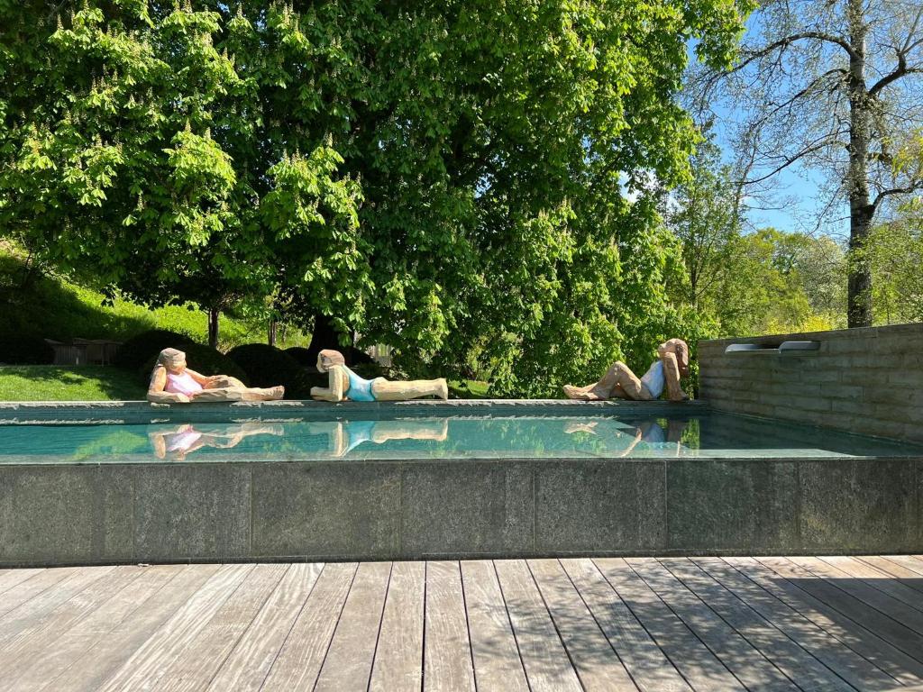 a group of people laying in a pool in a park at bed,Beet&breakfast „ds aute Pfarrhuus“ in Rapperswil