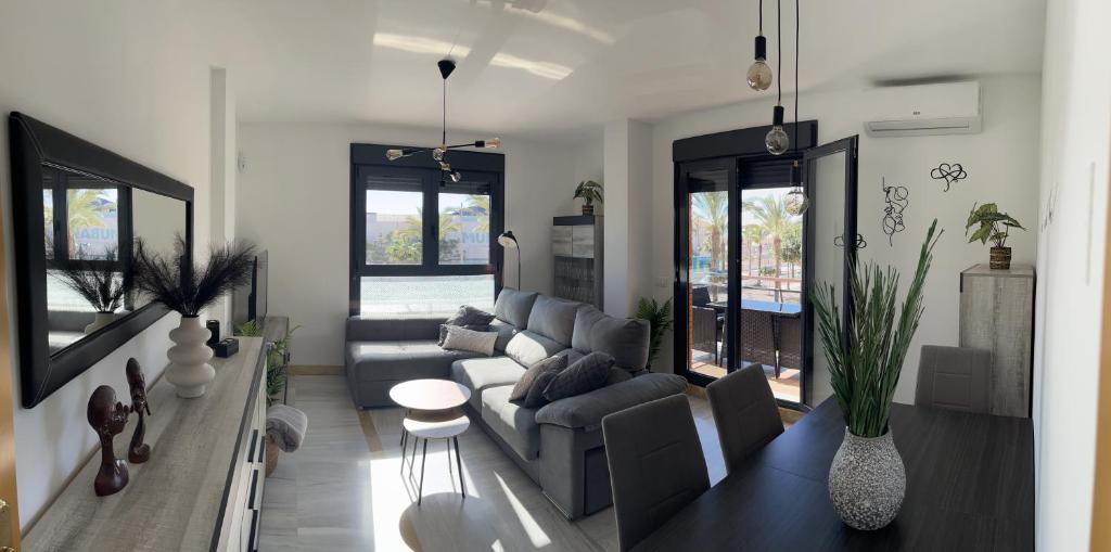 a living room with a couch and a table at Apartamento en Roquetas de Mar. in Aguadulce