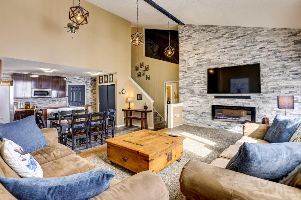 a living room with a couch and a fireplace at The Skiing Moose in Granby