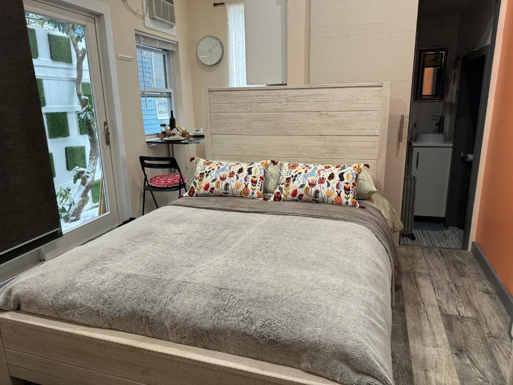 a bedroom with a large bed and a window at California guest house in Greenwich