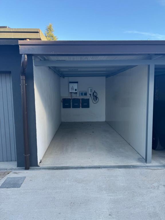 an open garage with a white wall at Apartment near Como and Milan with private garage in Mozzate