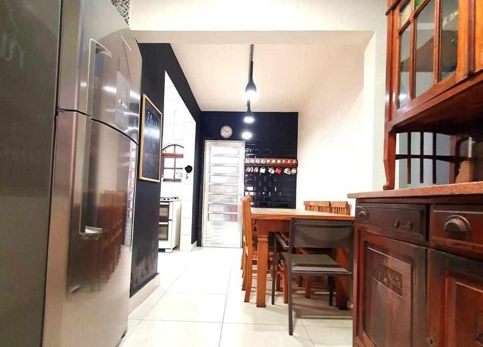 uma cozinha com um frigorífico e uma mesa com cadeiras em Casa 146 - SP Expo, Metrô, Congonhas em São Paulo