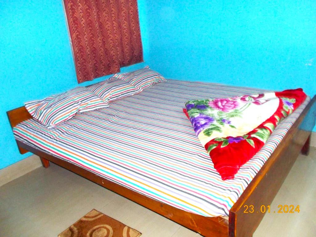 a bed with two pillows on top of it at GRG Nakshatra By Digha in Digha