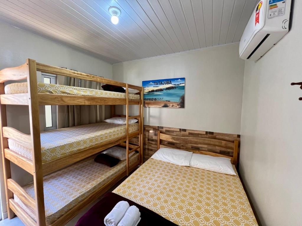 a room with three bunk beds in it at CASA BRANCA - Jijoca de Jericoacoara in Jijoca de Jericoacoara