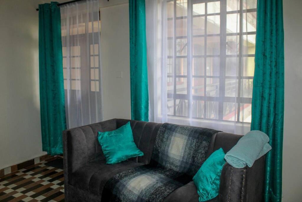 a living room with a couch and a window at Eagles one bedroom in Kisii CBD with Balcony in Kisii