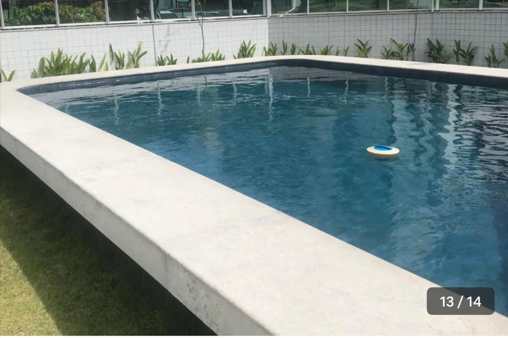 a swimming pool with a ball in the water at Flat em Boa Viagem in Recife