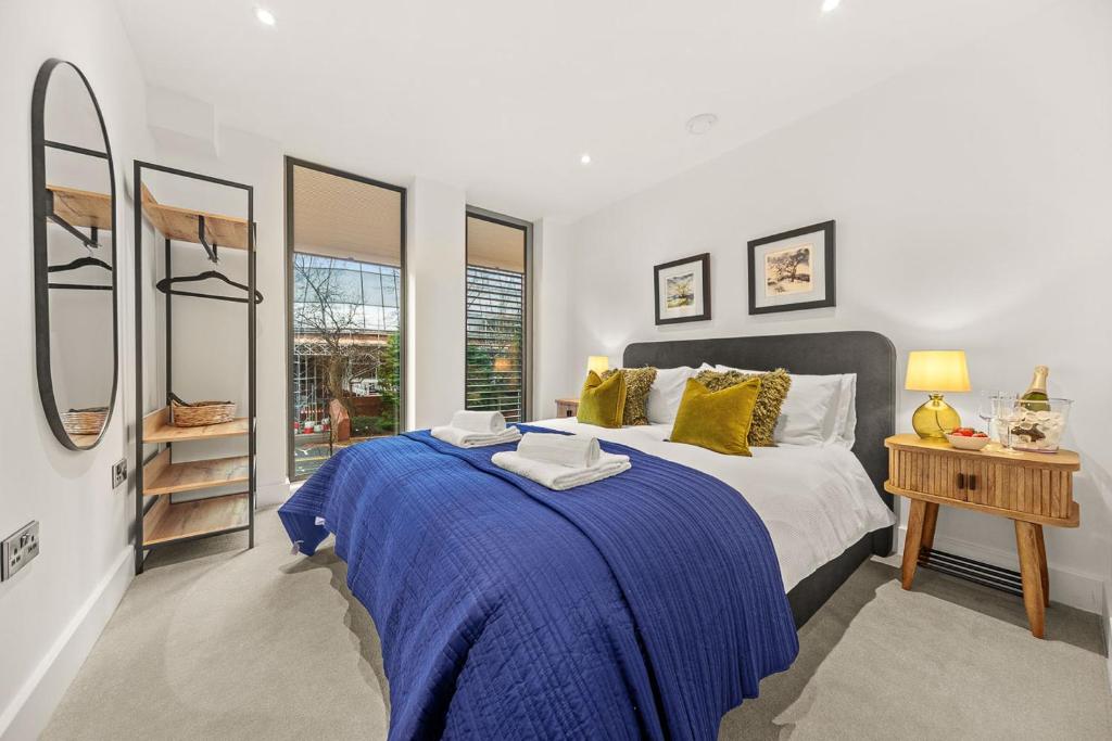 a bedroom with a large bed with a blue blanket at Atlas House Three in Harrogate