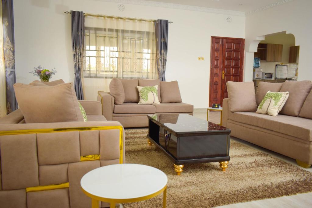 a living room with couches and a coffee table at Casa Nadreya in Nakuru