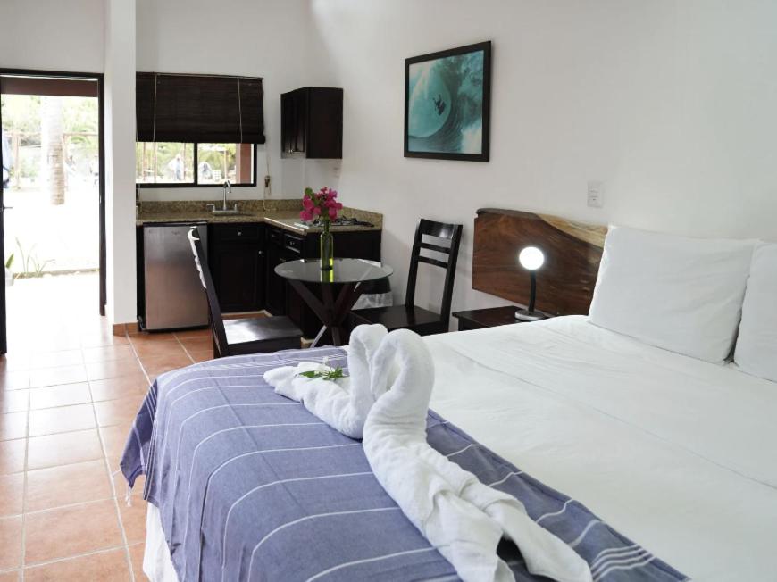 a bedroom with a bed with a towel on it at Room to Roam in Rivas