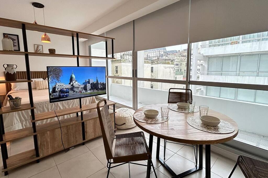 a dining room with a table and a tv in a room at BALC0611 Depto Exclusivo: Piscina y Comodidad en Montserrat in Buenos Aires