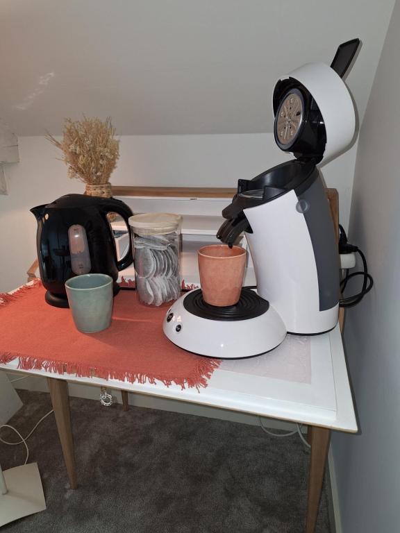 a coffee maker and a tea kettle on a table at La chambre Mademoiselle Causeuse in Malville