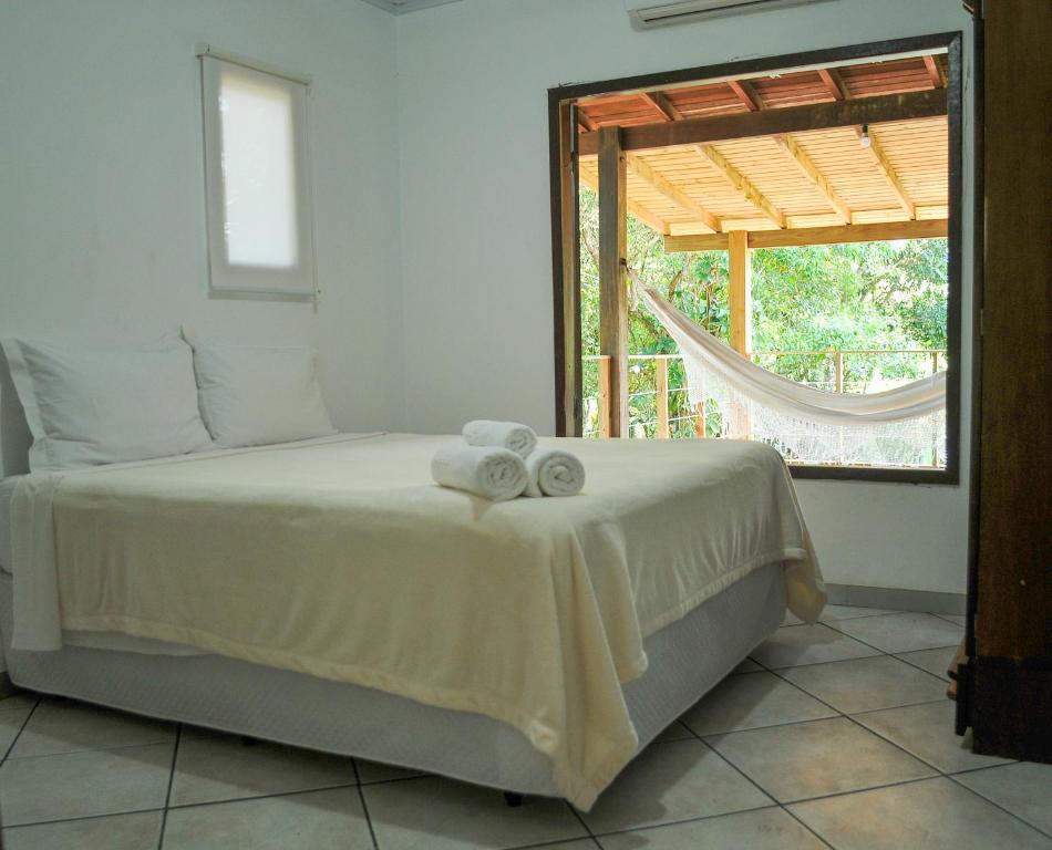 Un pat sau paturi într-o cameră la Lagoa Hospedaria