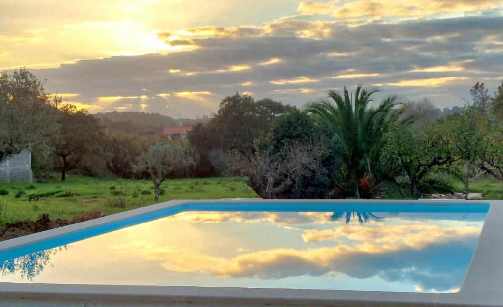 a swimming pool with a sky in the water at Casa Alegria - The Orangery 