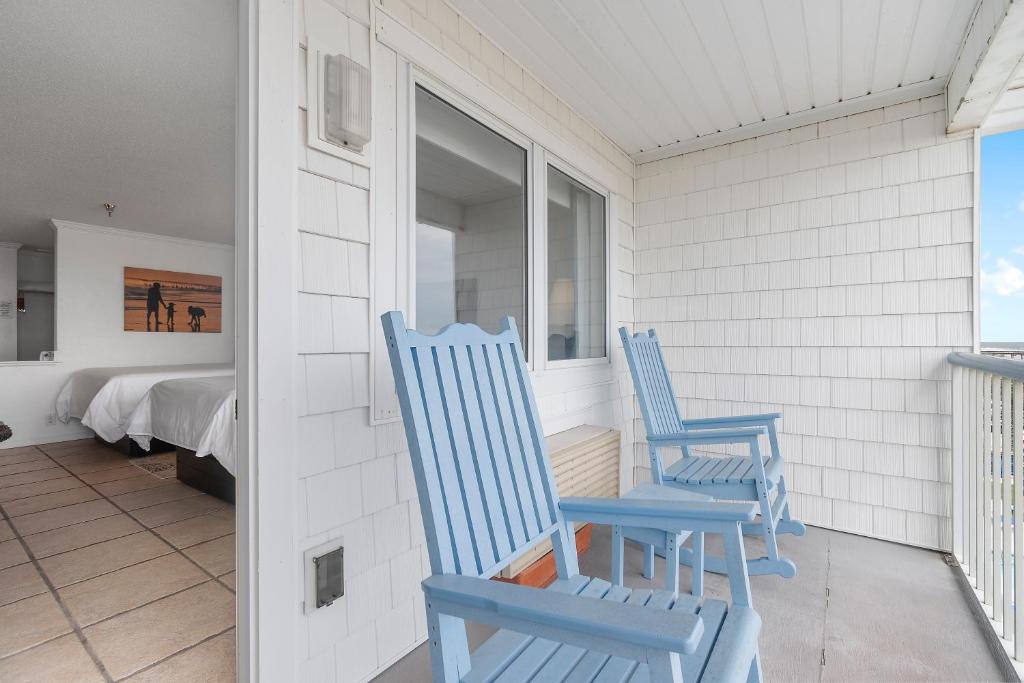 two blue rocking chairs sitting on a porch at Ocean Isle Inn in Ocean Isle Beach