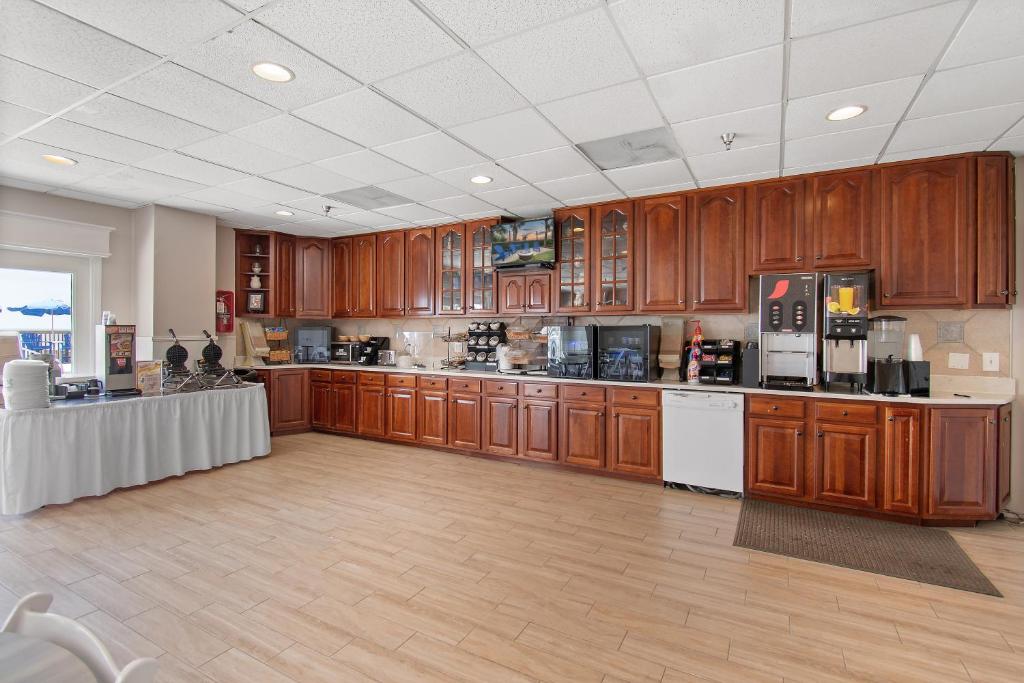 a large kitchen with wooden cabinets and appliances at Ocean Isle Inn in Ocean Isle Beach