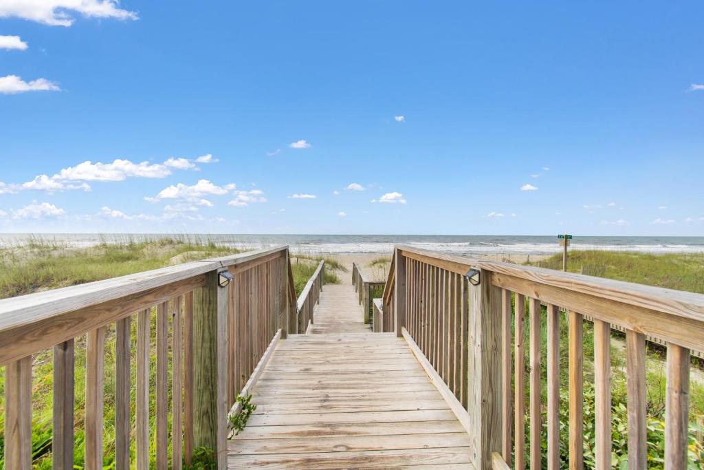 a wooden boardwalk leading to the beach at Ocean Isle Inn in Ocean Isle Beach