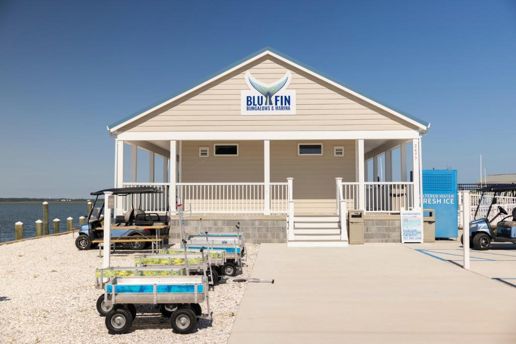 a building with a sign on it on the beach at Blufin Bungalows & Marina in Chincoteague