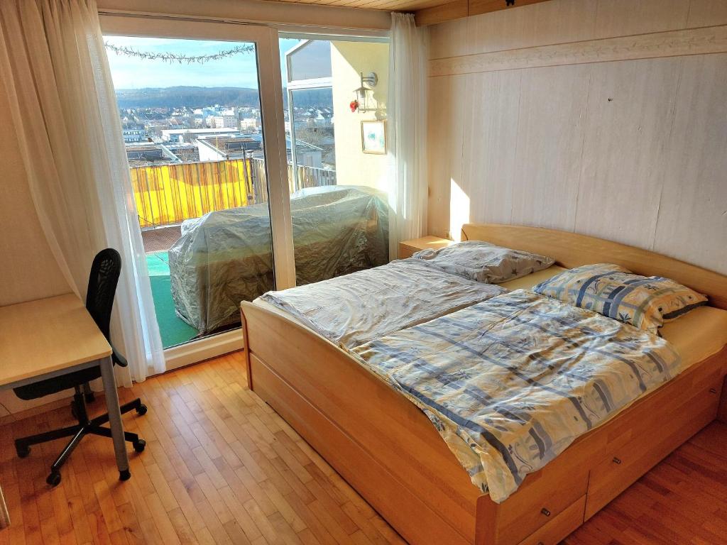 a bedroom with a bed and a large window at Make yourself at home in Vaihingen an der Enz