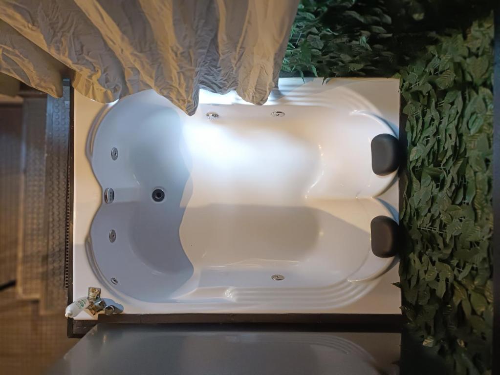 a bath tub in a bathroom with a window at Loft Sagitárius - Central Zone - Lotk1 in Rio de Janeiro