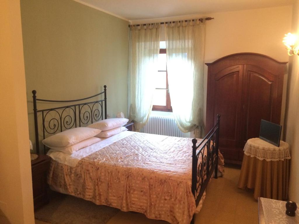 Postel nebo postele na pokoji v ubytování Agriturismo I Chiosi
