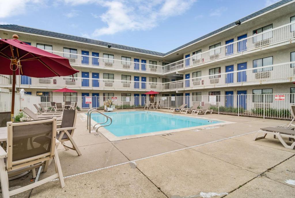 un edificio de apartamentos con piscina y muebles de exterior en Motel 6-Rolling Meadows, IL - Chicago Northwest, en Rolling Meadows