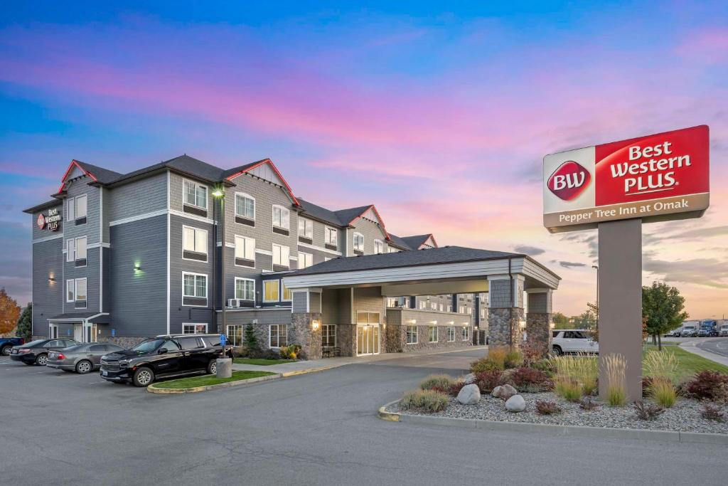 a best western plus sign in front of a hotel at Best Western PLUS Peppertree Inn at Omak in Omak