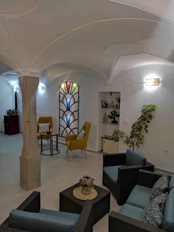 a lobby with couches and chairs and a stained glass window at CASA RURAL ELENYR in Calera de León