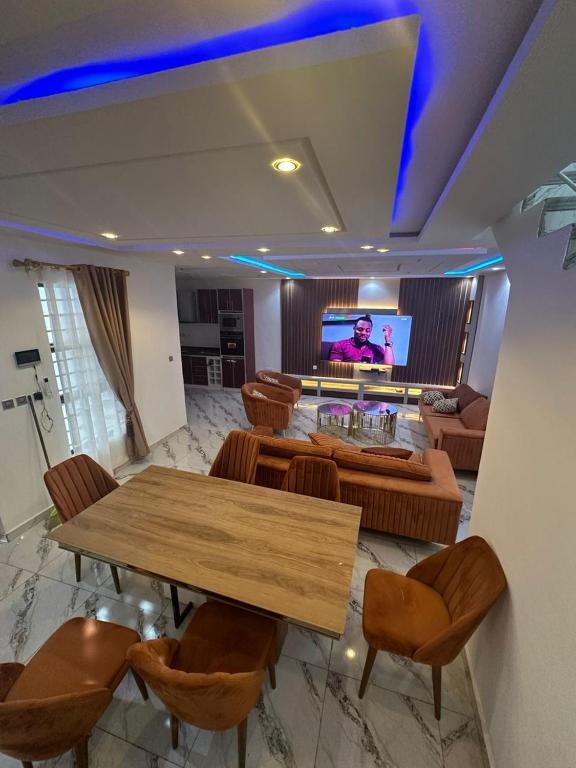 a living room with a table and a tv at GOP HOUSE in Madina