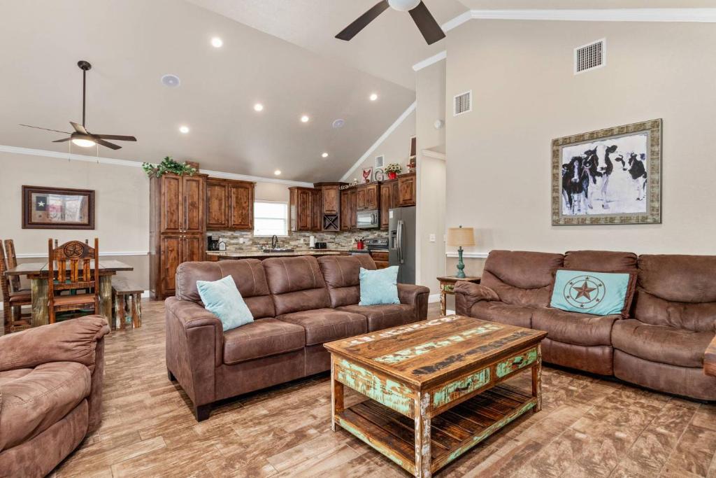 a living room with two couches and a table at River Road Villas #2 in New Braunfels