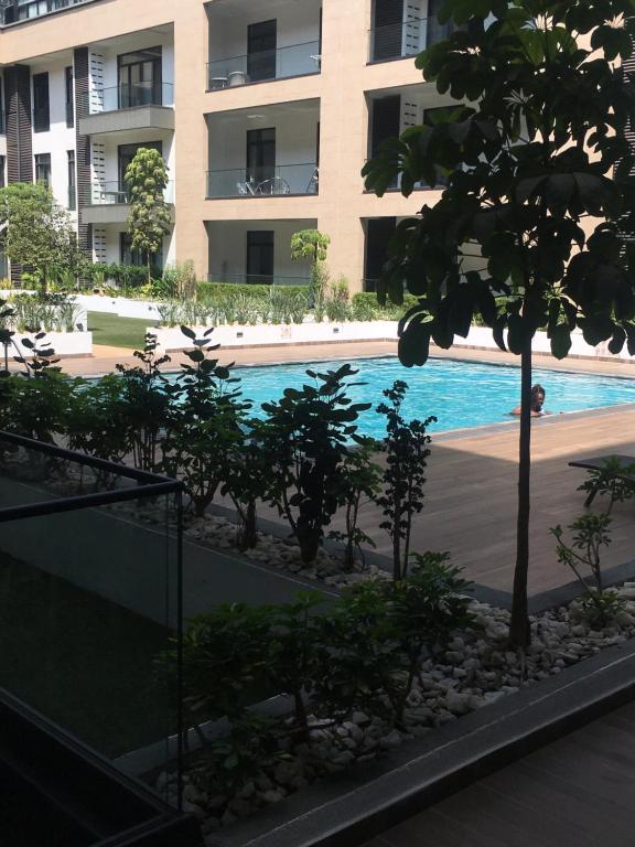 a swimming pool in front of a building at Embassy Gardens pool view in Accra