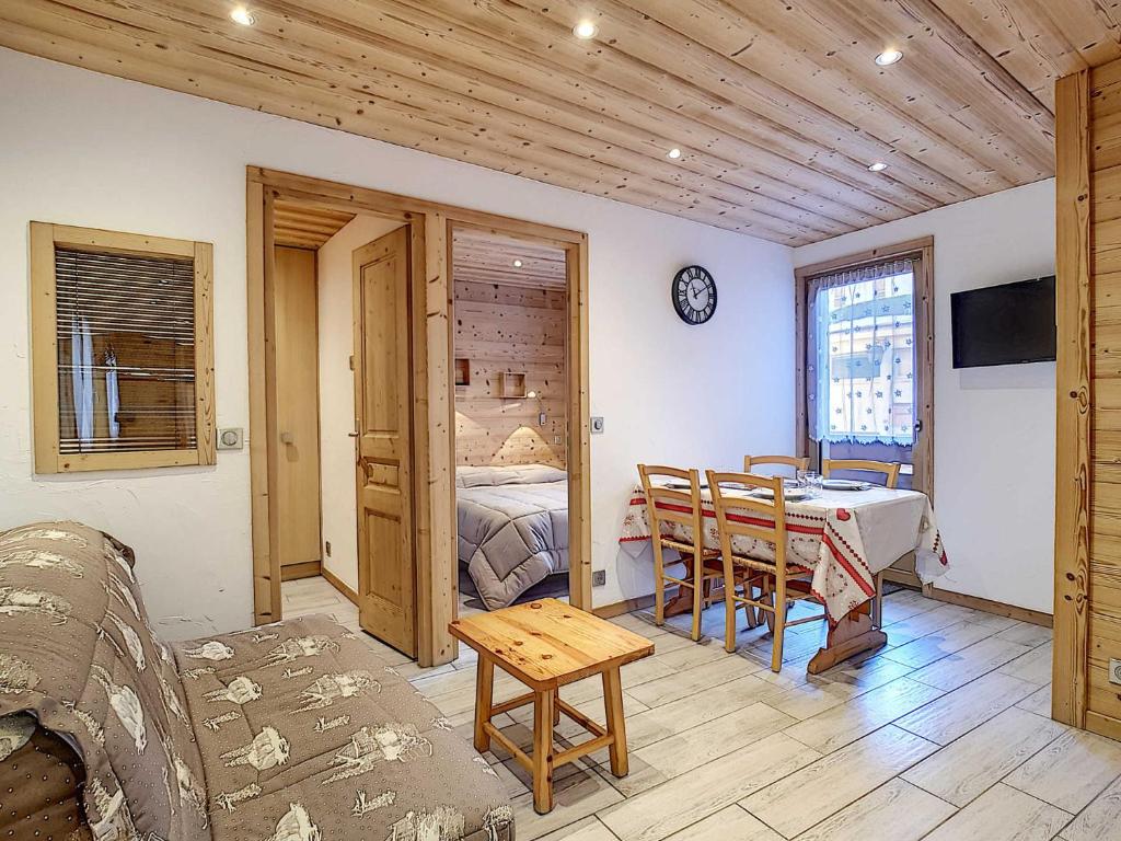 a living room with a bed and a table at La Ruche RU0490 in La Clusaz