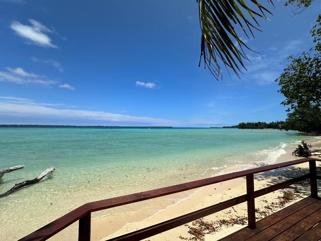 a view of the beach from a deck at Entire Beach Front Resort Home - Tides Reach Beach House in Saraotou