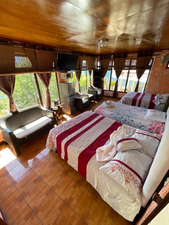 una cama en el medio de una habitación en un barco en Atitlan Inn, en Jucanyá
