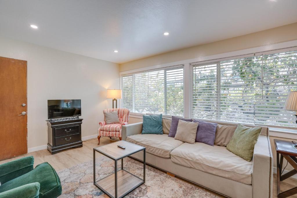 a living room with a couch and a window at Charming Oakland Apartment Near Lake Merritt! in Oakland