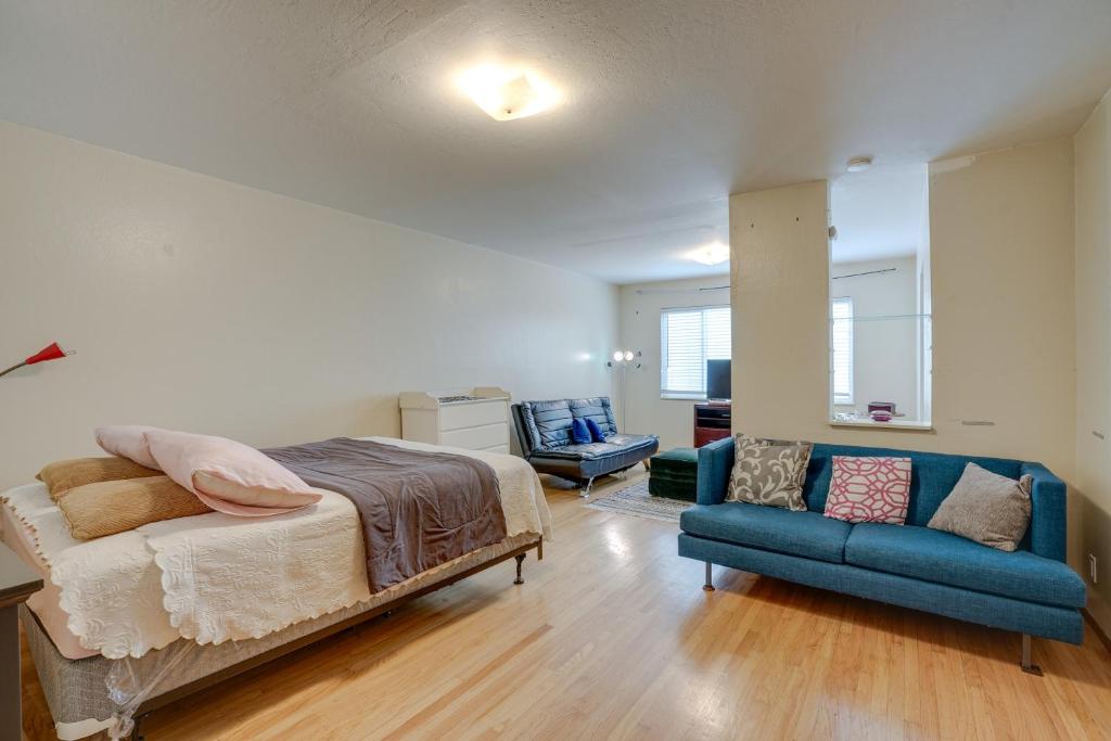 a bedroom with a bed and a blue couch at Cozy Oakland Studio Rental, 13 Mi to San Francisco in Oakland