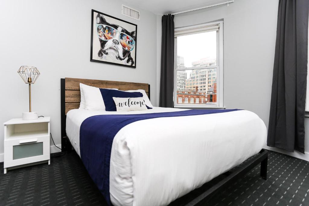 a bedroom with a large bed and a window at Charming Studio on Boston's Iconic Newbury St. #8 in Boston