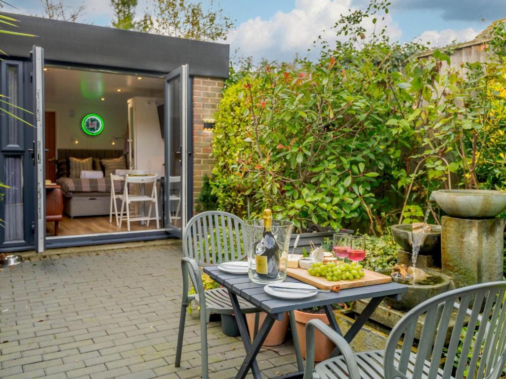 a table with a plate of food on a patio at 1 Bed in Highcliffe 90444 in Highcliffe